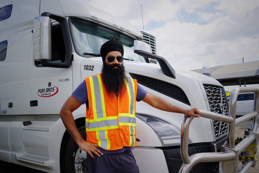 Picture of Truck Driver standing by Truck